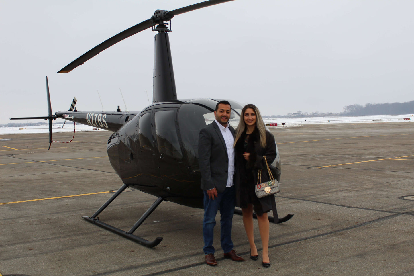 Columbus Helicopters Black Robinson R44 with Couple after Flight